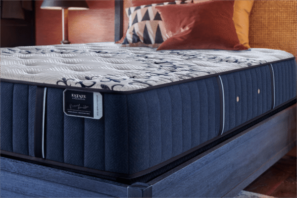 Close-up of the Stearns & Foster Estate Tight Top Luxury Firm Mon Trésor mattress showing the quilted surface, Estate Collection label, and premium side upholstery.
