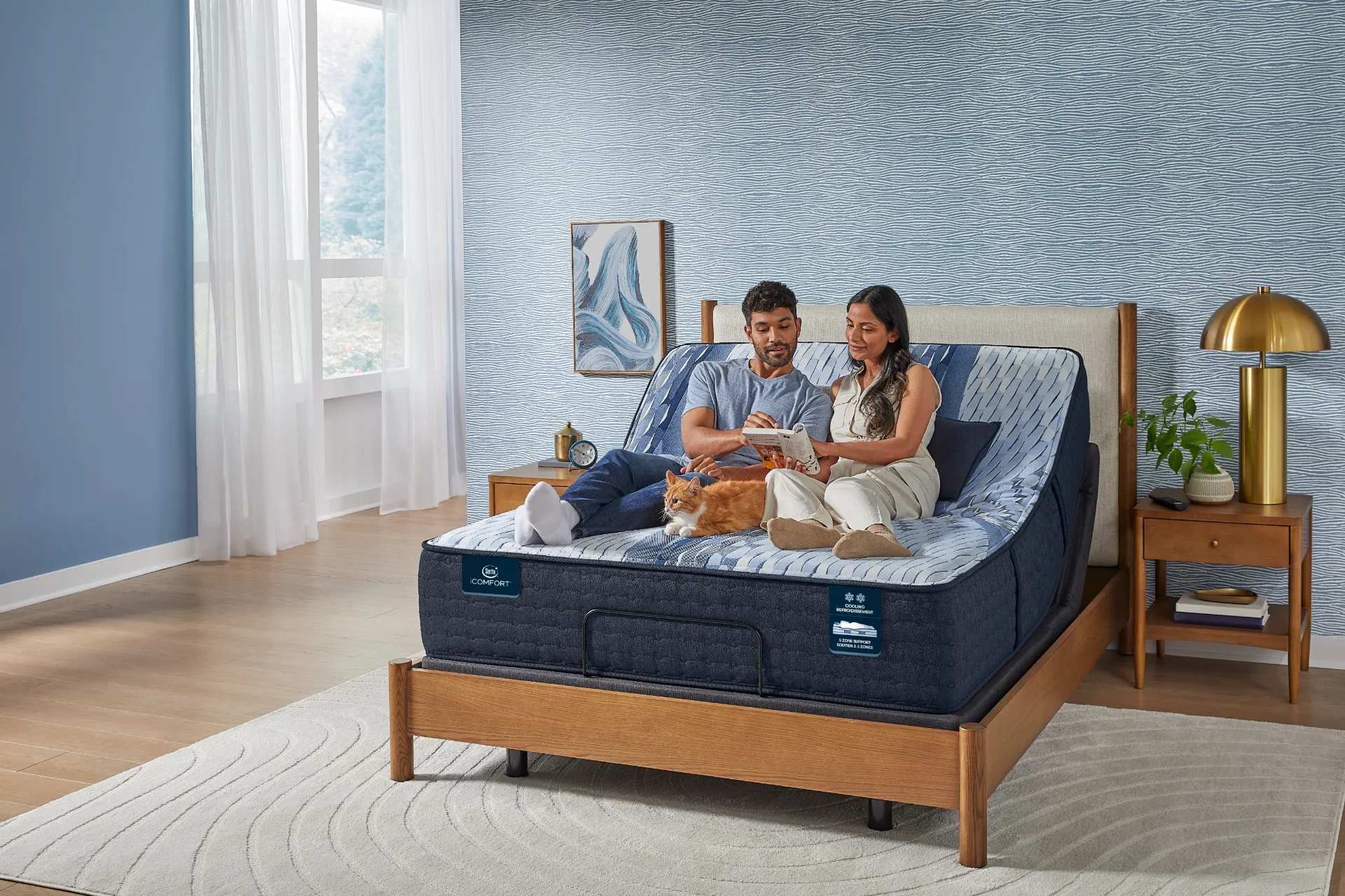 Couple relaxing on a Serta iComfort Opera mattress on an adjustable base